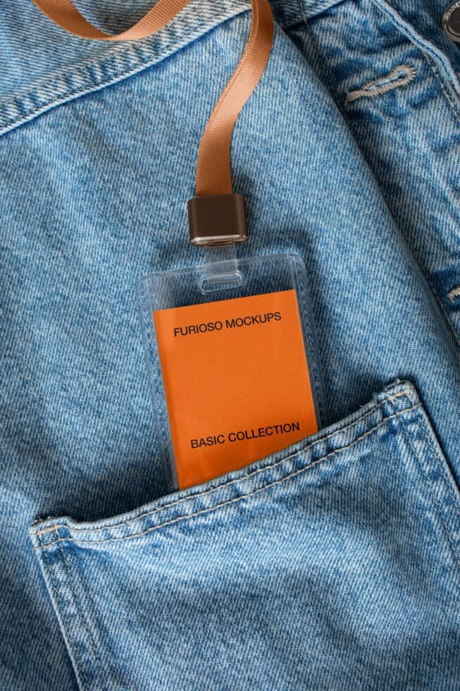 Orange ID badge on denim with brown clip, coral strap, label mockup