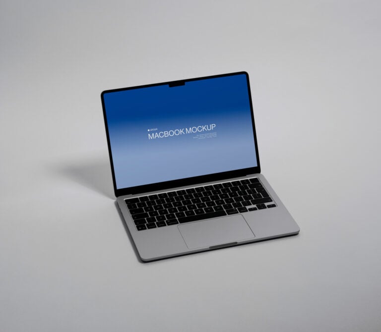 Silver macbook showing blue gradient screen with centered mockup text