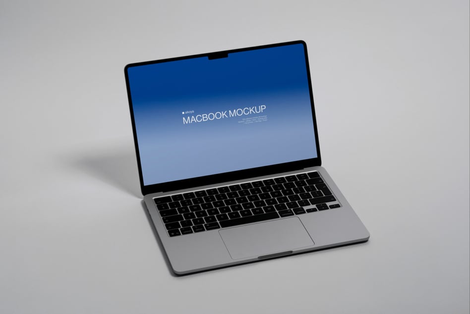 Silver macbook displaying blue gradient screen with white centered text