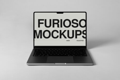 Laptop screen open with cream mockup displayed on black keyboard