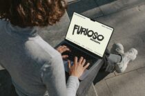 Overhead view of person with laptop showing cream screen with black Furioso text