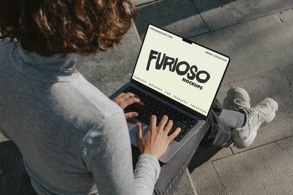 Overhead view of person with laptop showing cream screen with black Furioso text