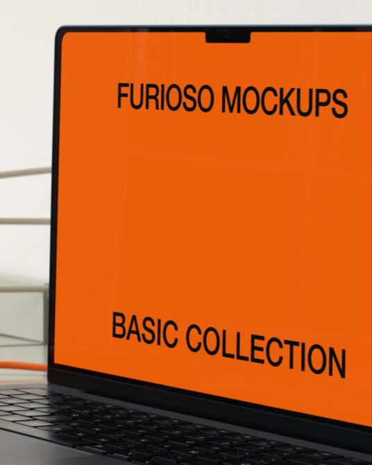 Laptop angled view with bright orange screen against white background