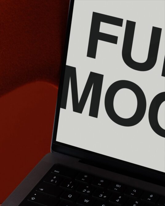 Laptop screen showing bold black text on white background with keyboard visible