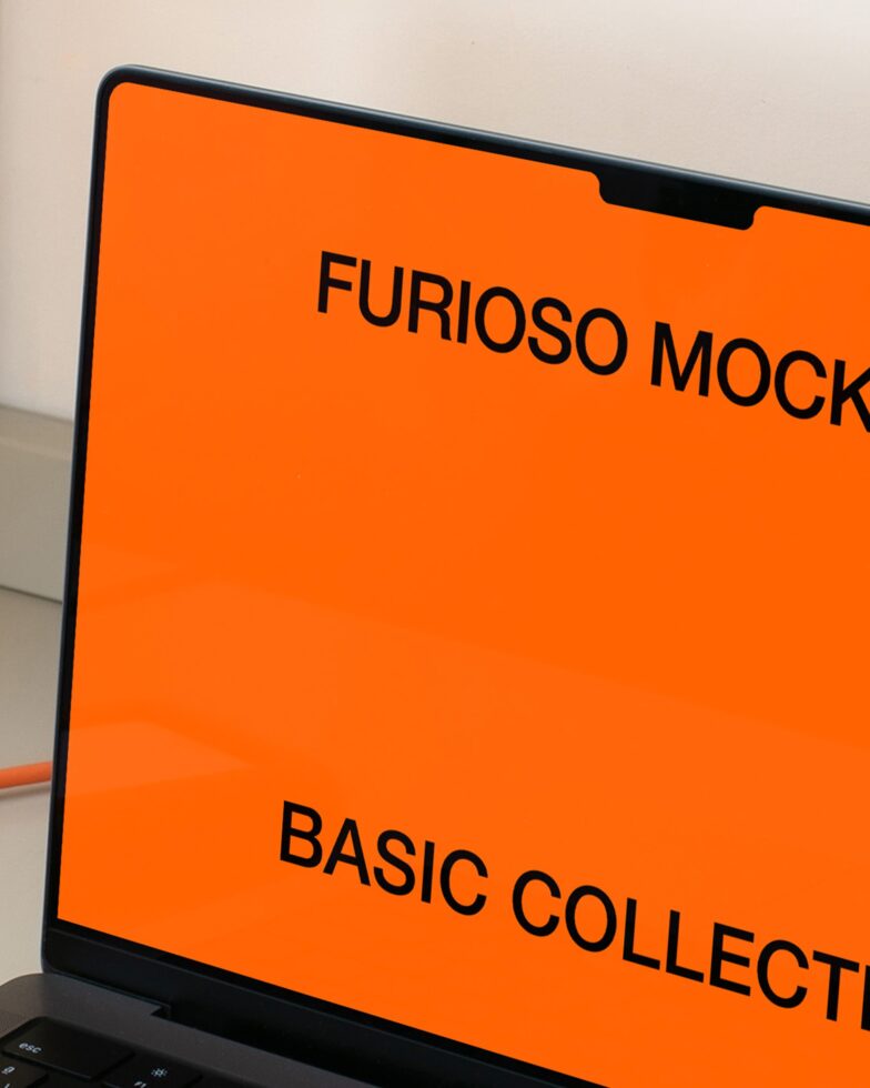 Close-up laptop screen showing orange Furioso Mockups Basic Collection text layout