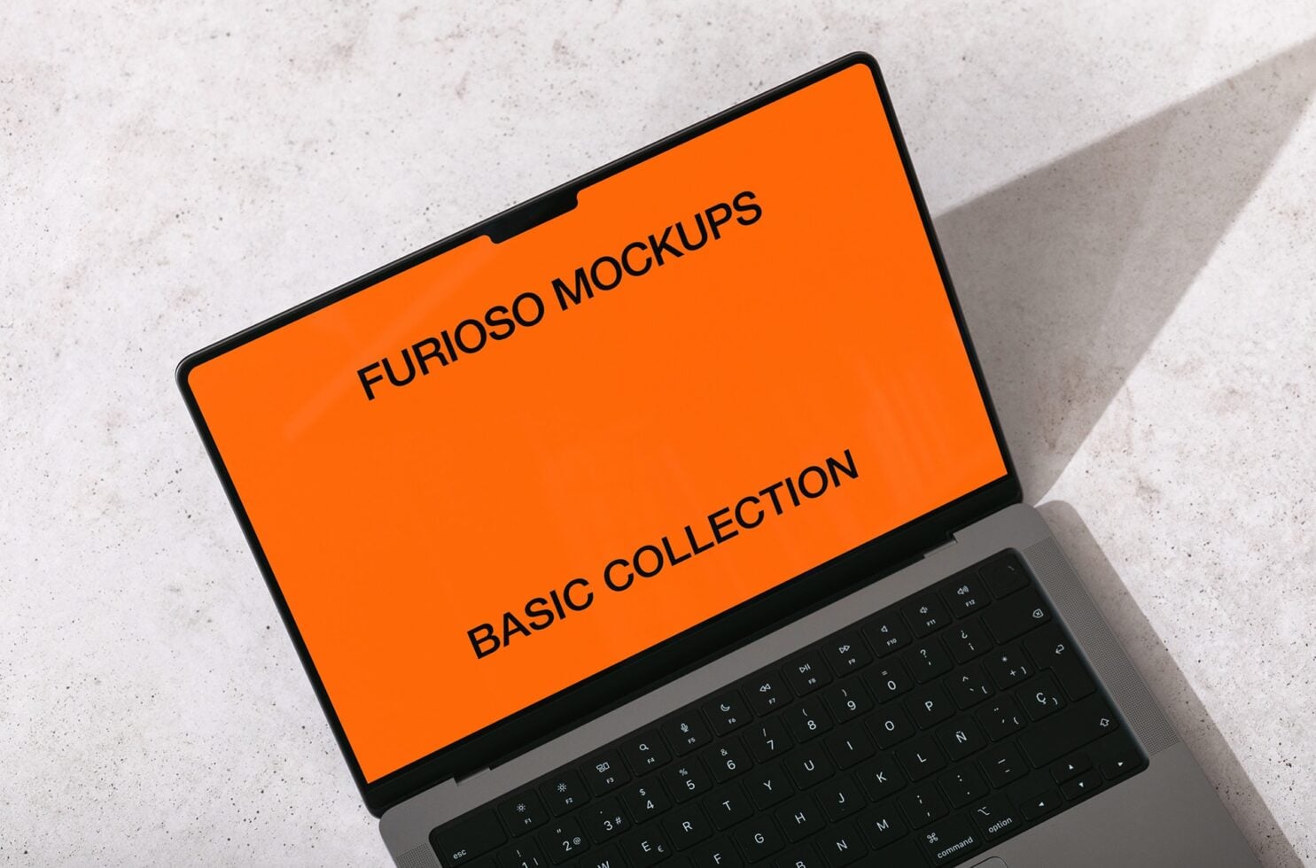 Overhead view of laptop with bright orange screen showing Furioso Mockups Basic Collection