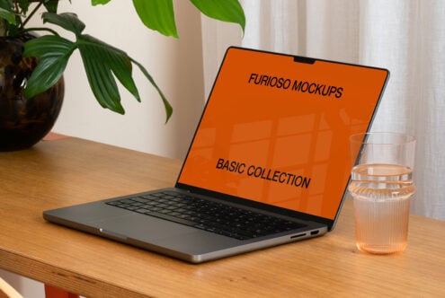Laptop screen showing orange background with Furioso Mockups Basic Collection text