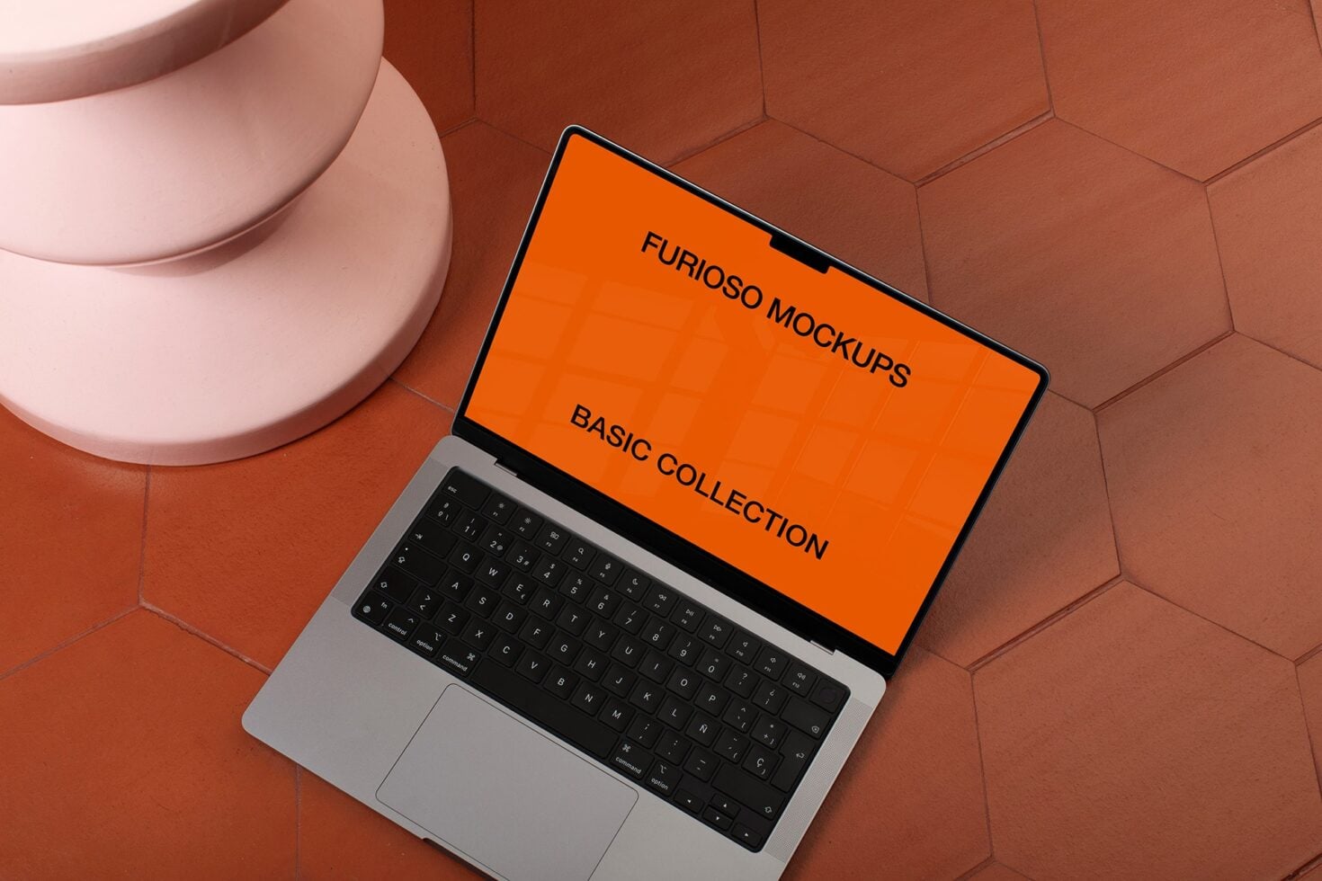 Open laptop with orange screen mockup on geometric tile background with pink object