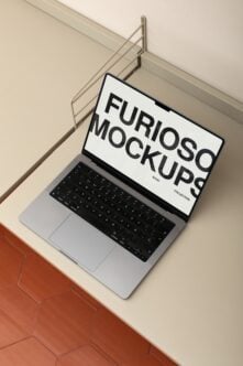 Laptop displaying white mockup screen on modern desk with metal rod backdrop