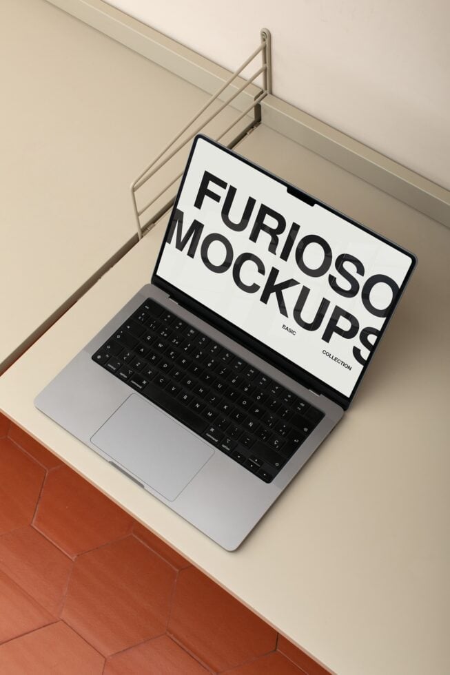 Laptop displaying white mockup screen on modern desk with metal rod backdrop