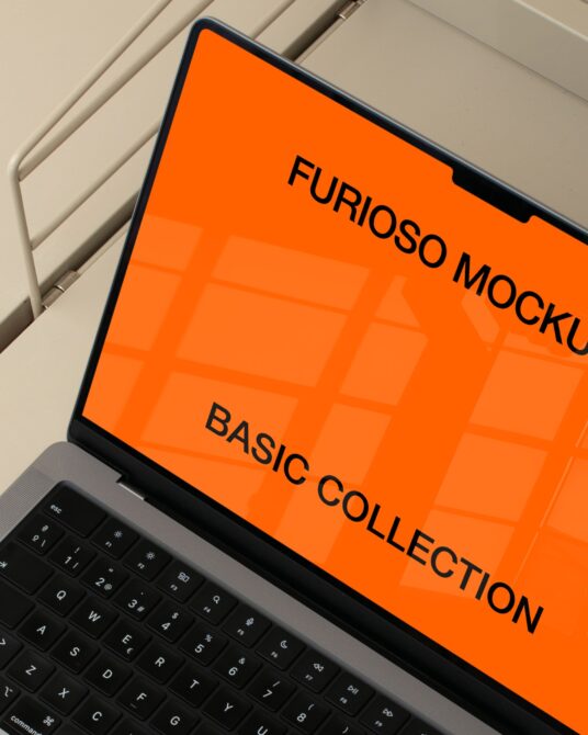 Laptop screen displaying bright orange mockup design with grid overlay pattern