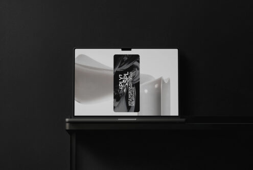 Laptop open showing bright minimal layout with centered device mockup