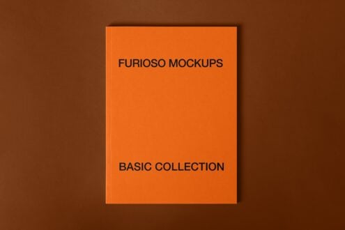 Flat lay of orange hardcover book on brown background showing Furioso Mockups Basic Collection