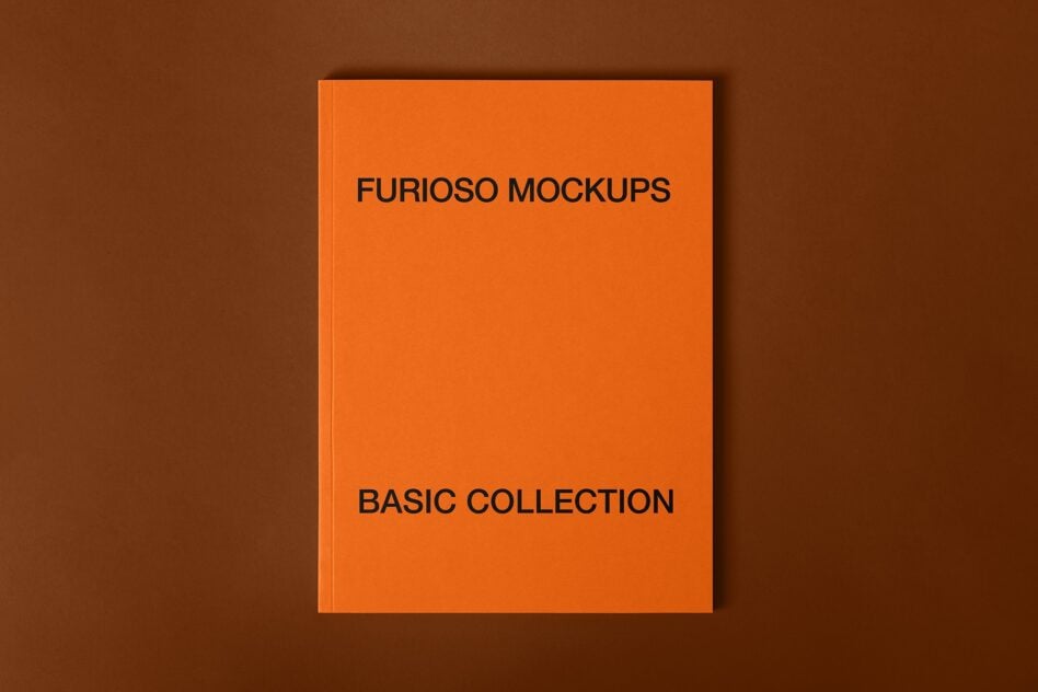 Flat lay of orange hardcover book on brown background showing Furioso Mockups Basic Collection