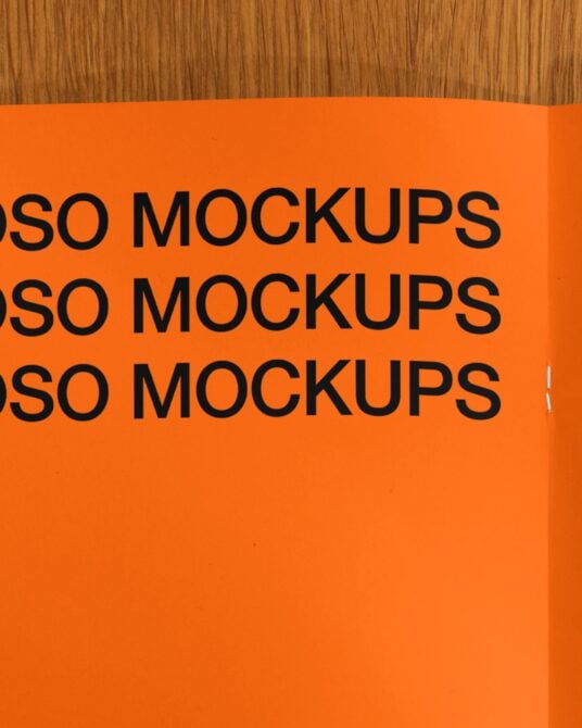 Orange curved magazine or brochure pages with repeated black text pattern