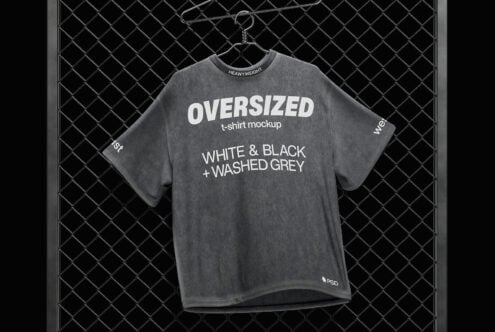 Washed grey oversized heavyweight t-shirt on hanger against chain-link fence mockup