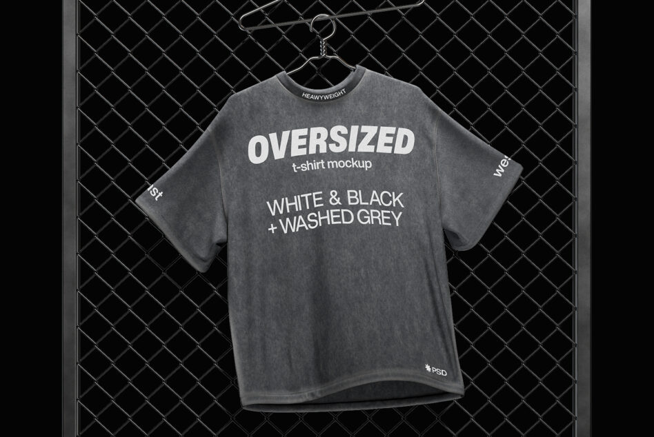 Washed grey oversized heavyweight t-shirt on hanger against chain-link fence mockup