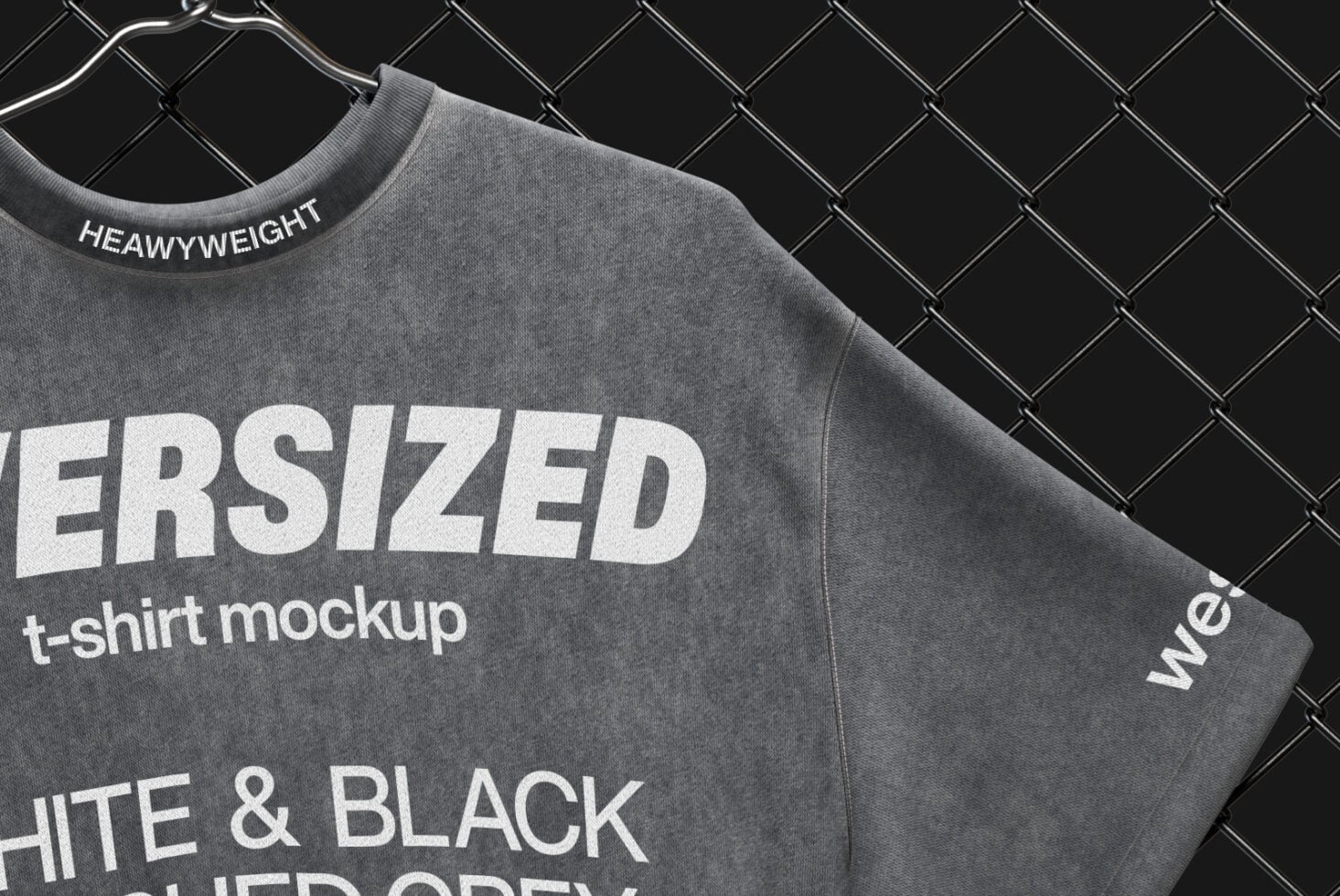 Charcoal tee sleeve detail with heavyweight label on chain-link background