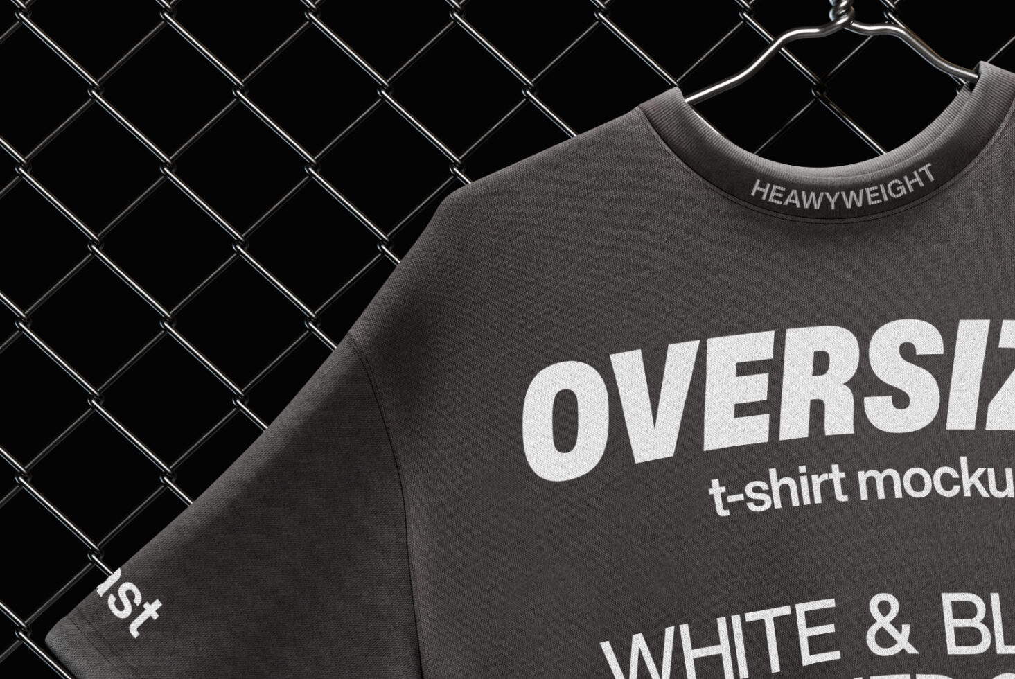 Oversized tee chest graphic close-up hanging on chain-link fence
