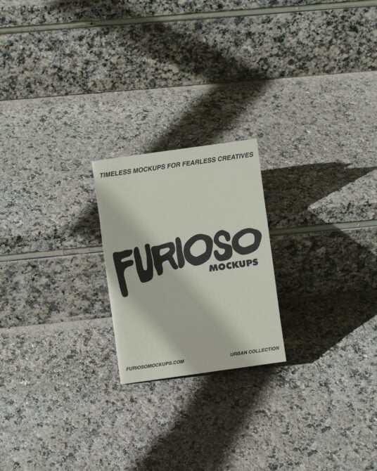 Cream card with black FURIOSO logo on textured concrete with sunlight