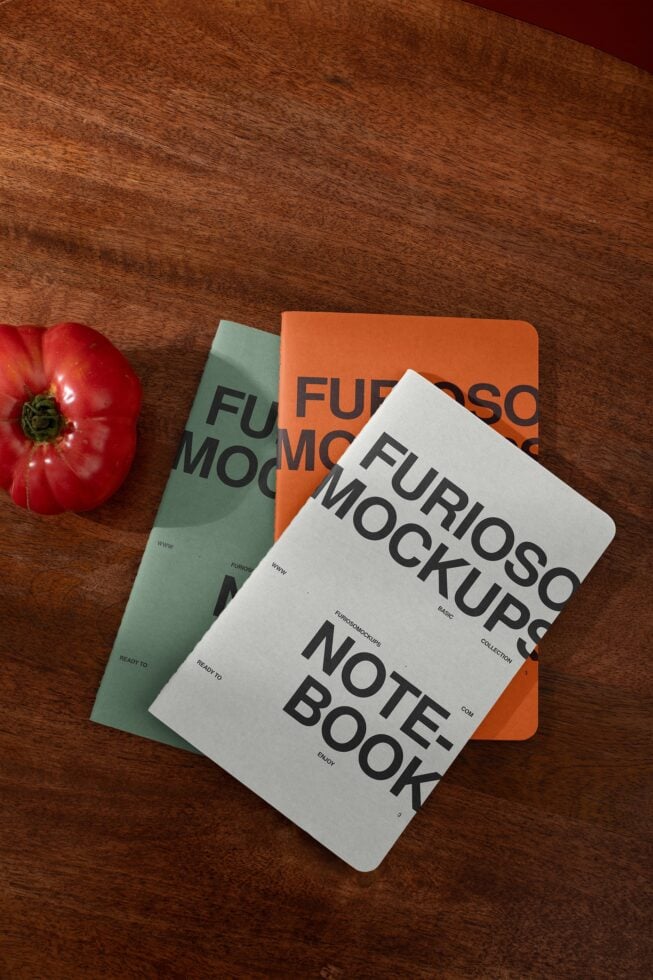 Three stacked notebook mockups on wood with fresh tomato, white orange cream covers with typography