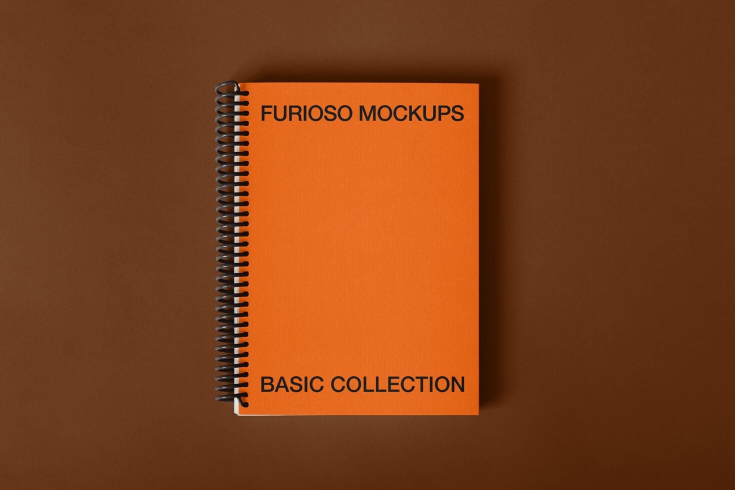 Orange spiral notebook cover mockup on brown background with minimal shadow