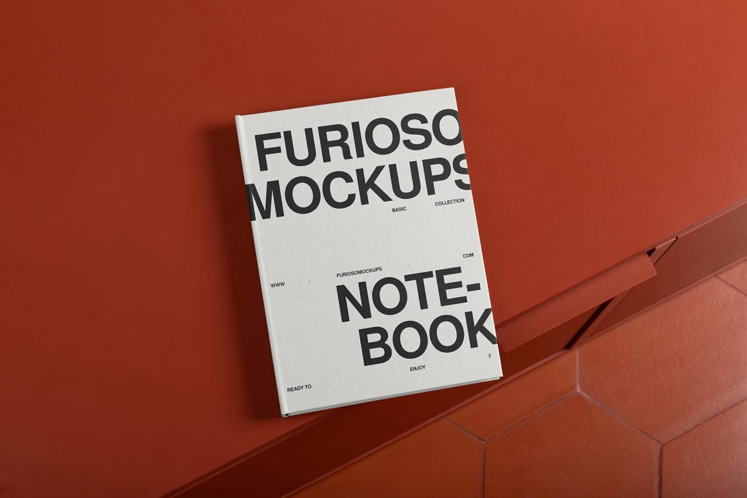 White notebook mockup positioned on terracotta hexagonal tile flooring