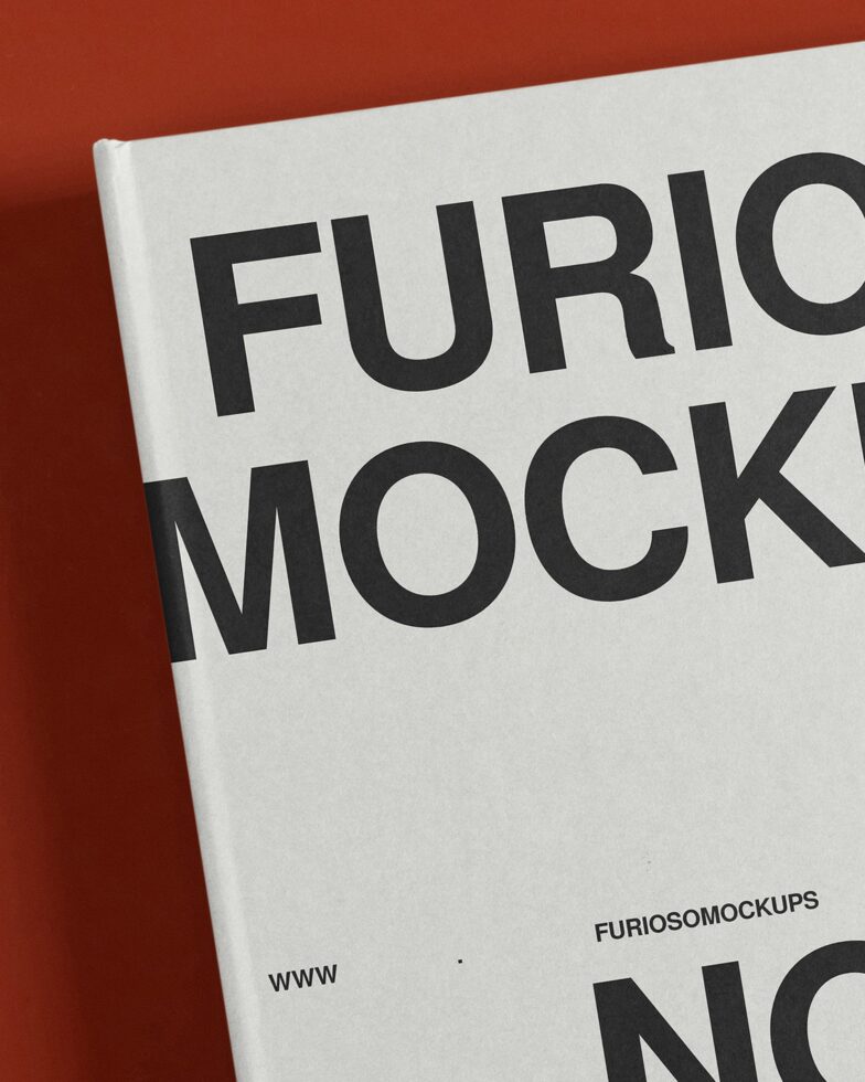 Close-up of printed notebook cover with bold black typography on red background