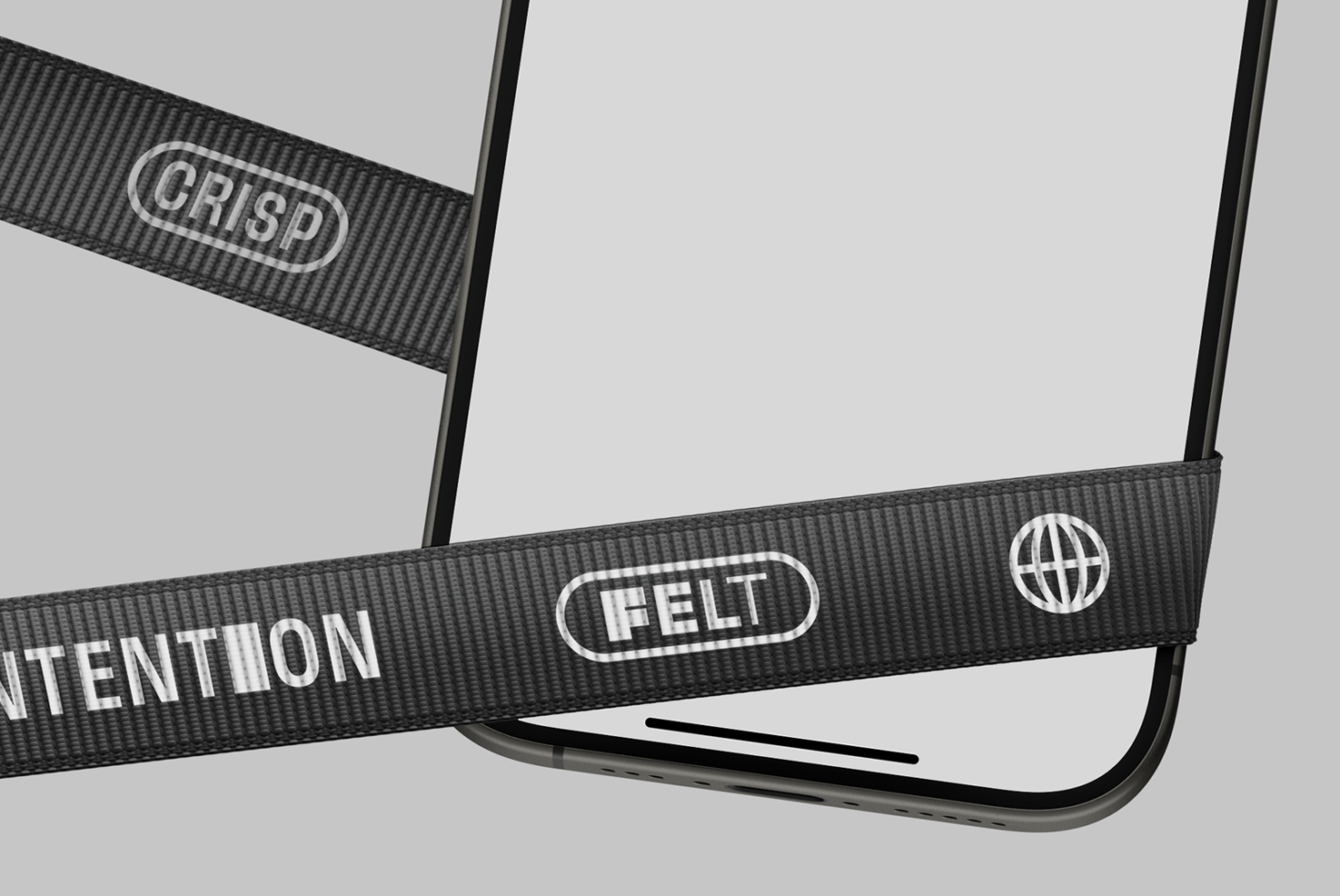 Close detail of dark ribbon crossing phone corner showing felt, intention, well-defined badges