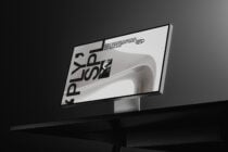 Monitor displaying minimalist product mockup with metallic object on screen