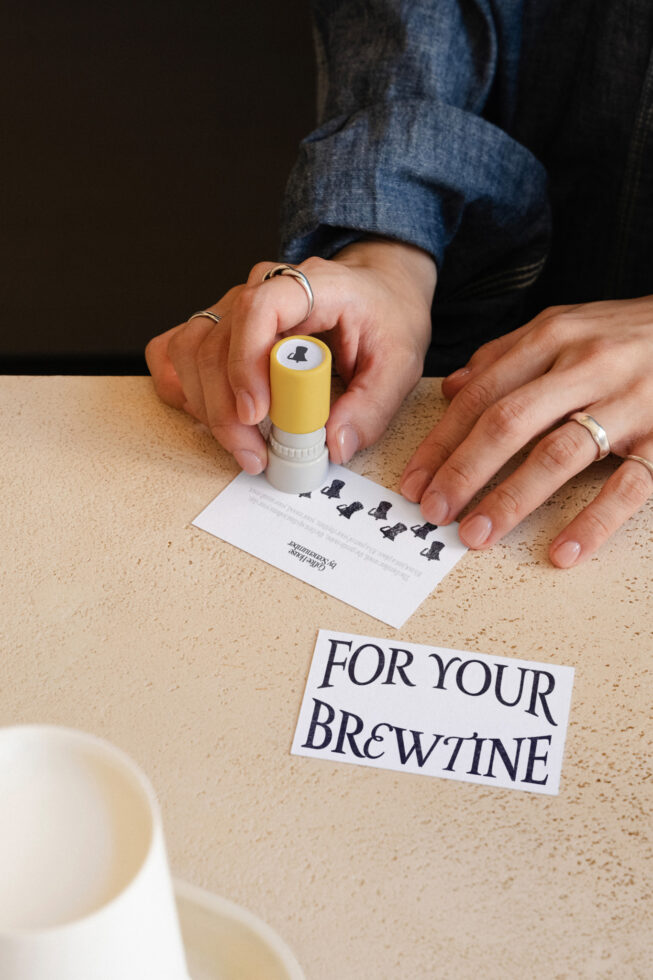 Stamp mockup with yellow cap pressing pattern onto white card stock