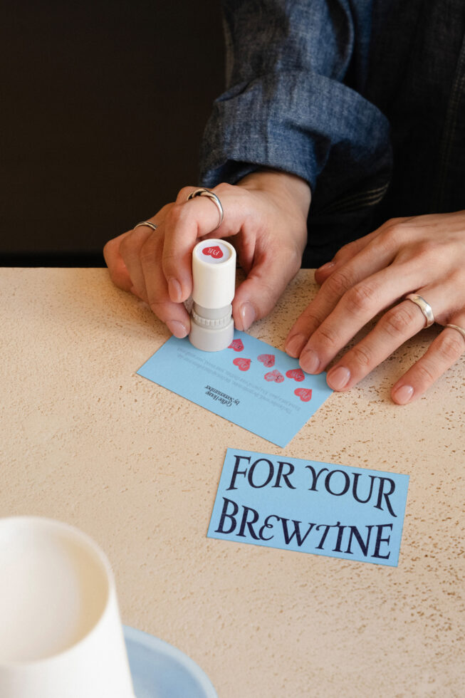 Stamp mockup pressing red hearts onto light blue card stock