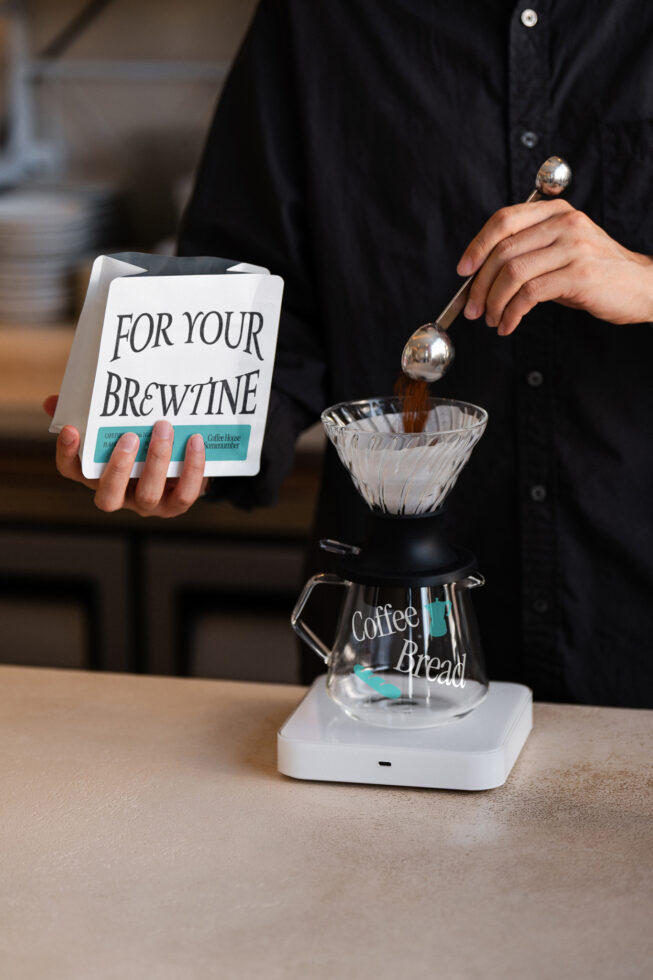 Pour-over coffee scene with turquoise accent on white bag mockup display