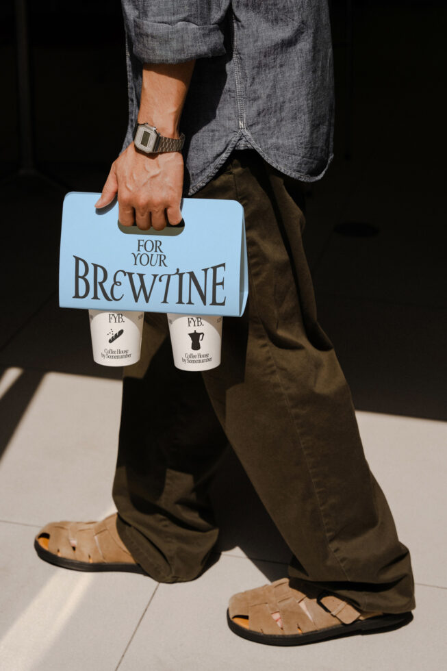 Man carrying light blue bag with two coffee cups mockup in casual outfit