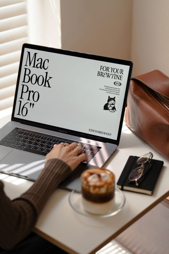 MacBook Pro 16 inch displaying coffee shop website with pastry beside it