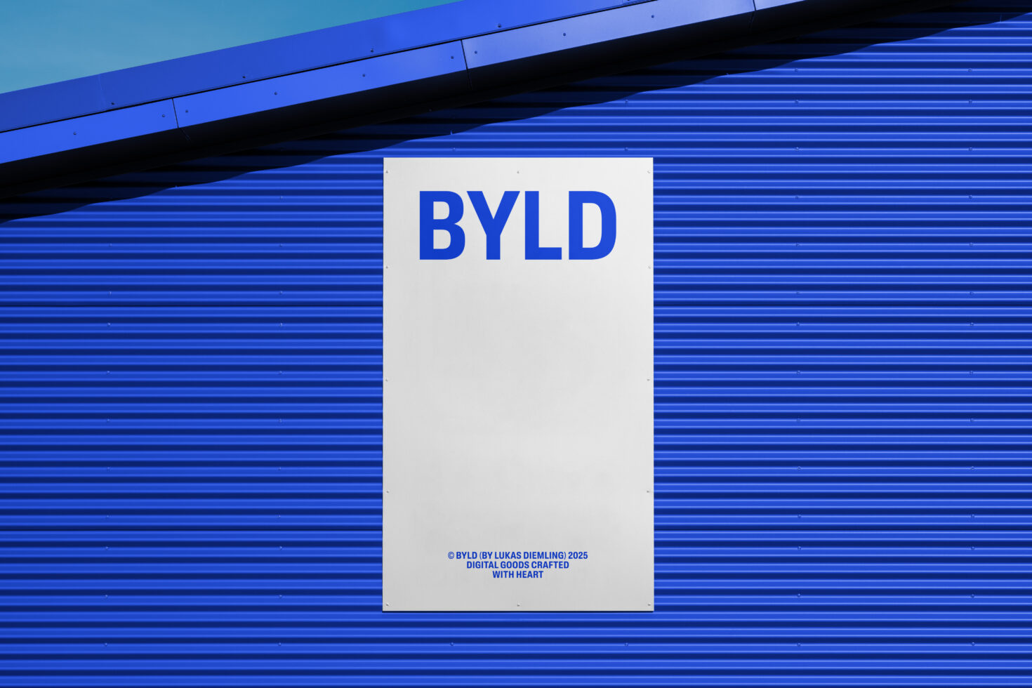 Blue corrugated metal wall with white BYLD sign mockup against sky