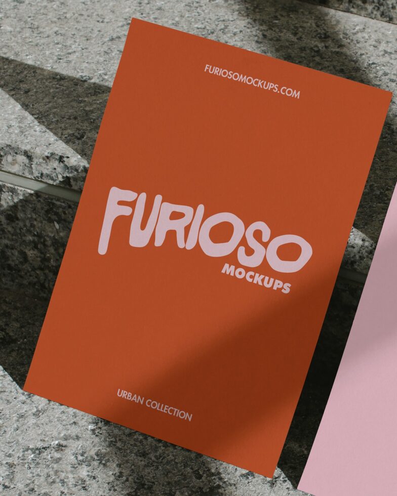 Bright orange card with pink FURIOSO lettering on concrete surface