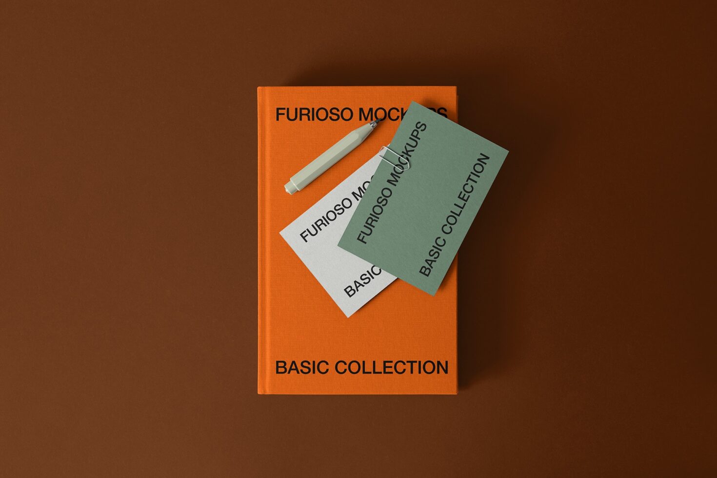 Orange book with layered cards showing Furioso Mockups branding with pen