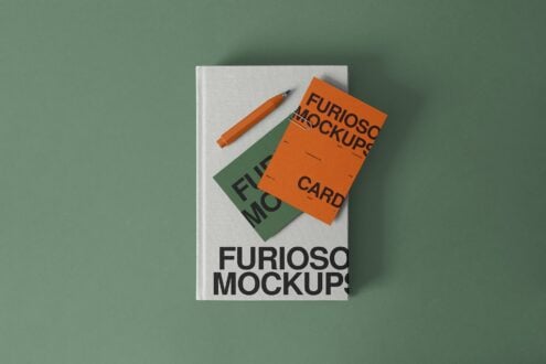 White notebook with orange business cards overlaid, orange pen on sage background