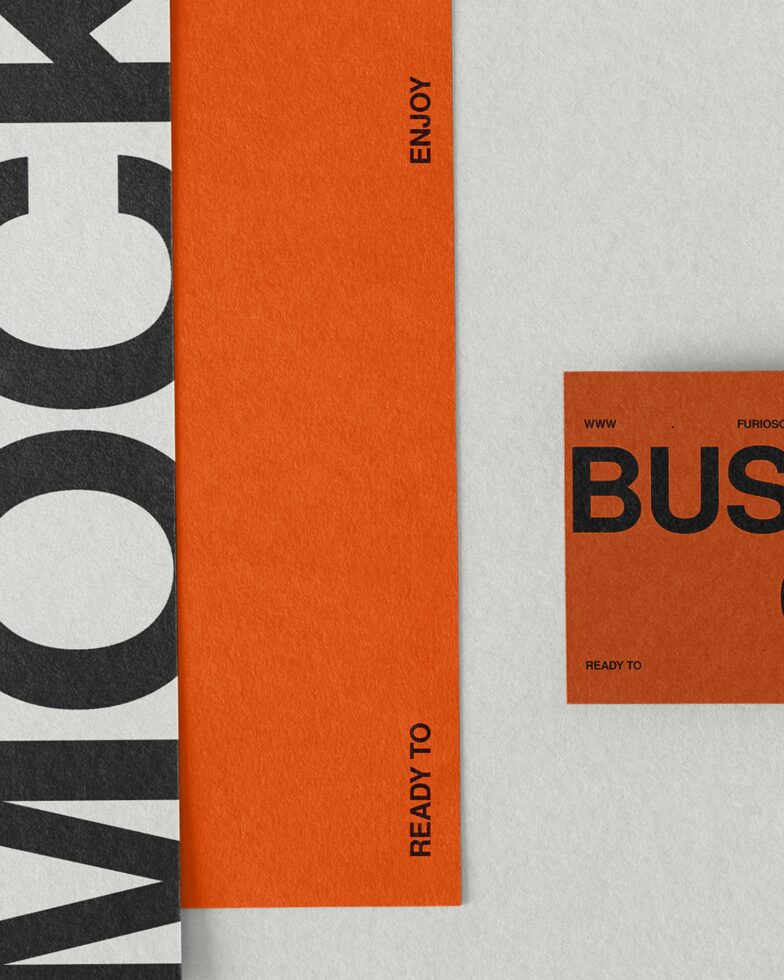 Orange spine folder displayed with black type on cream paper layout