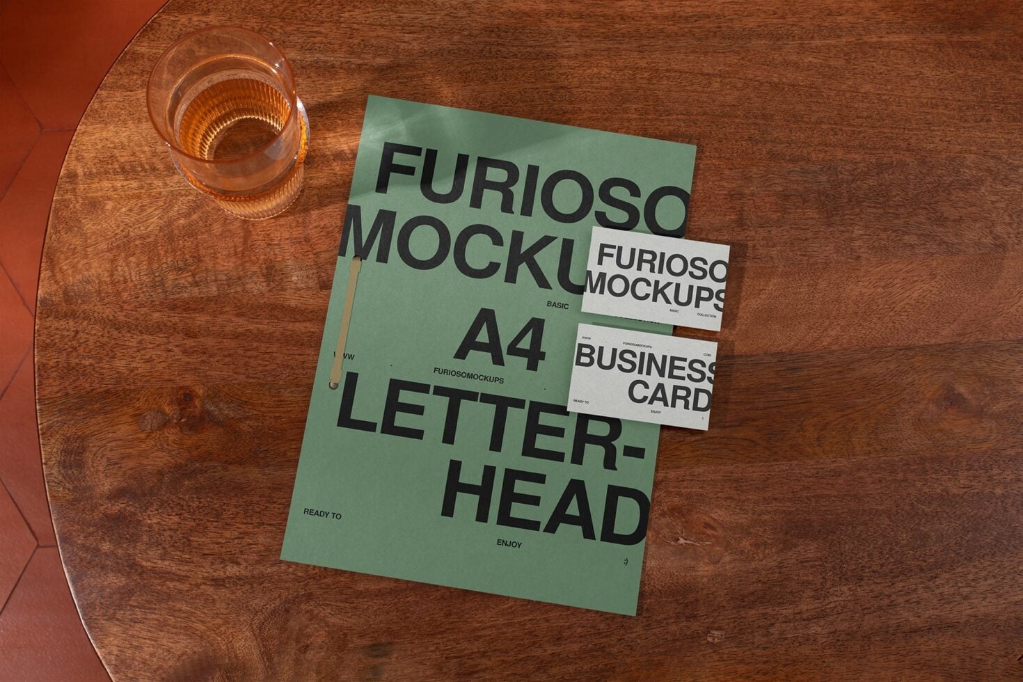 Green A4 letterhead with stacked business cards on wooden table mockup