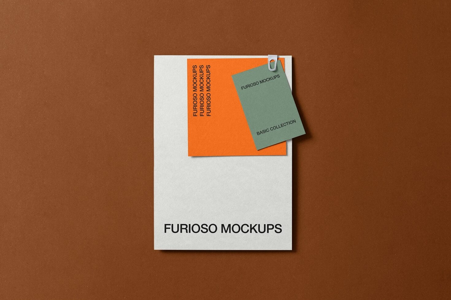 Business card mockup with green clip attached to orange card on white envelope