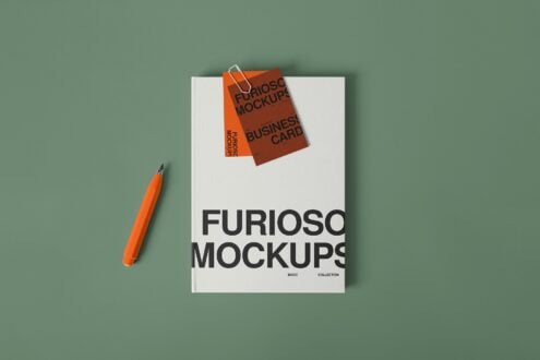 Open magazine mockup with business card floating above, orange pen nearby