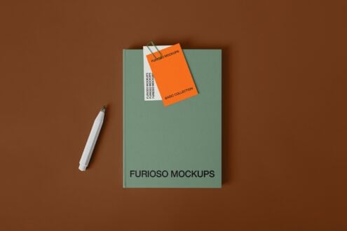 Sage notebook with orange business card mockup, pen on brown surface