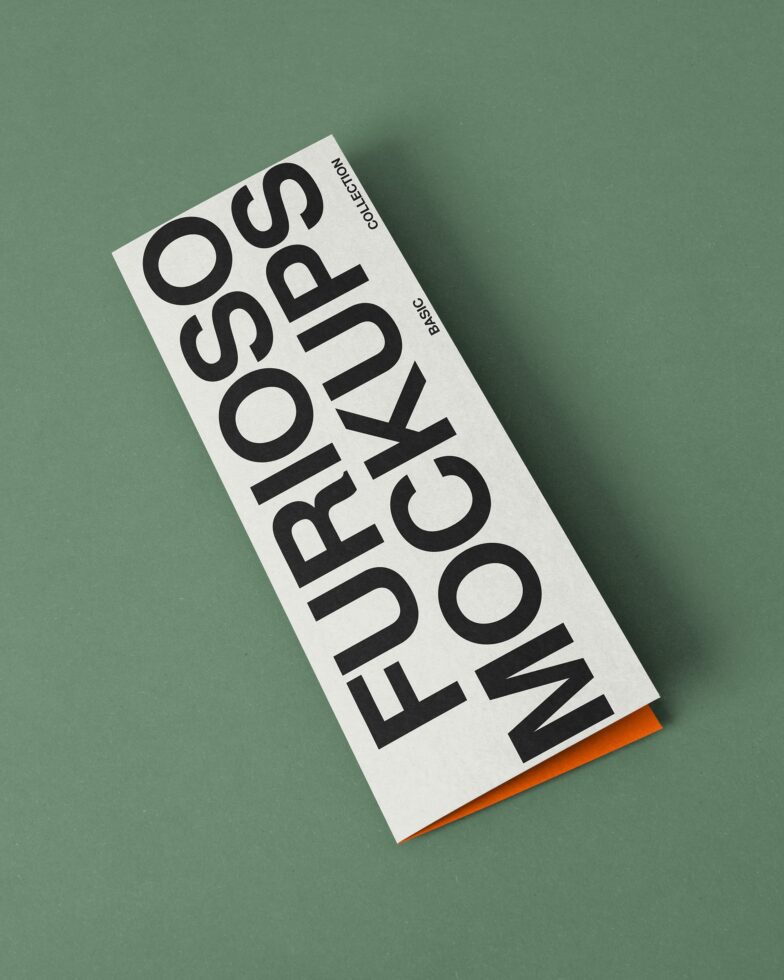 Folded brochure mockup with large stacked letters in black on white paper