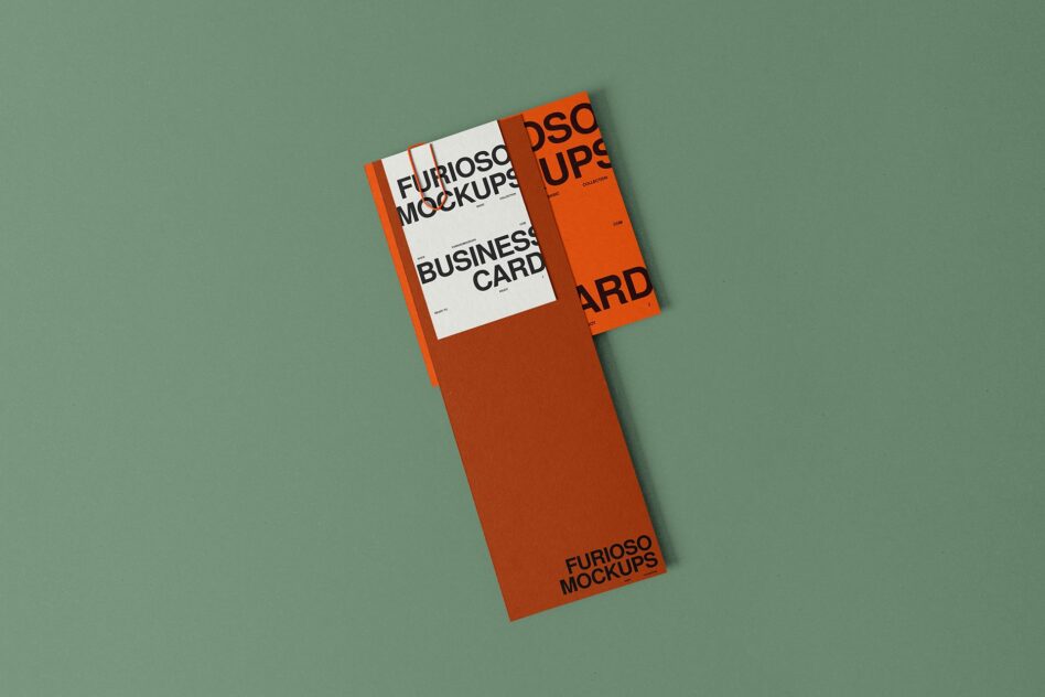 Business card mockups fanned out with orange tape on sage background