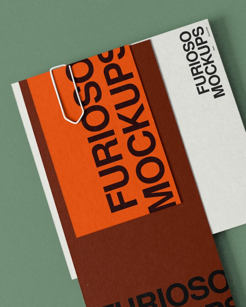 Orange furled business card mockup with brown side panel on green background