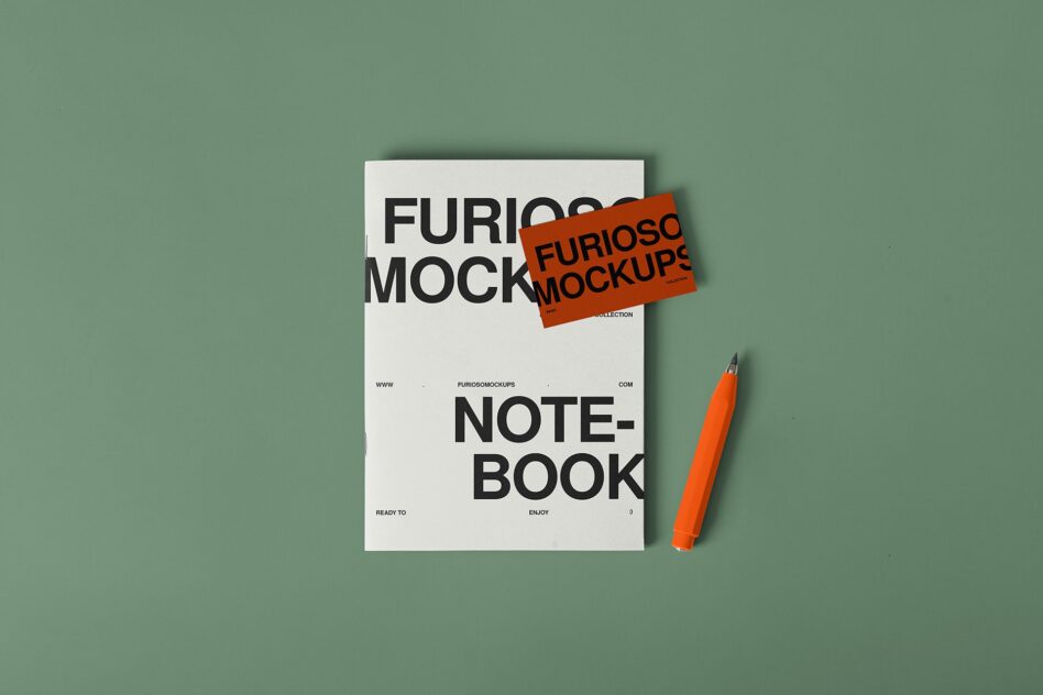 White notebook with orange sticker overlay next to orange marker on sage green background