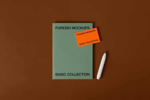 Sage green card with orange sticker label next to white pen on brown background