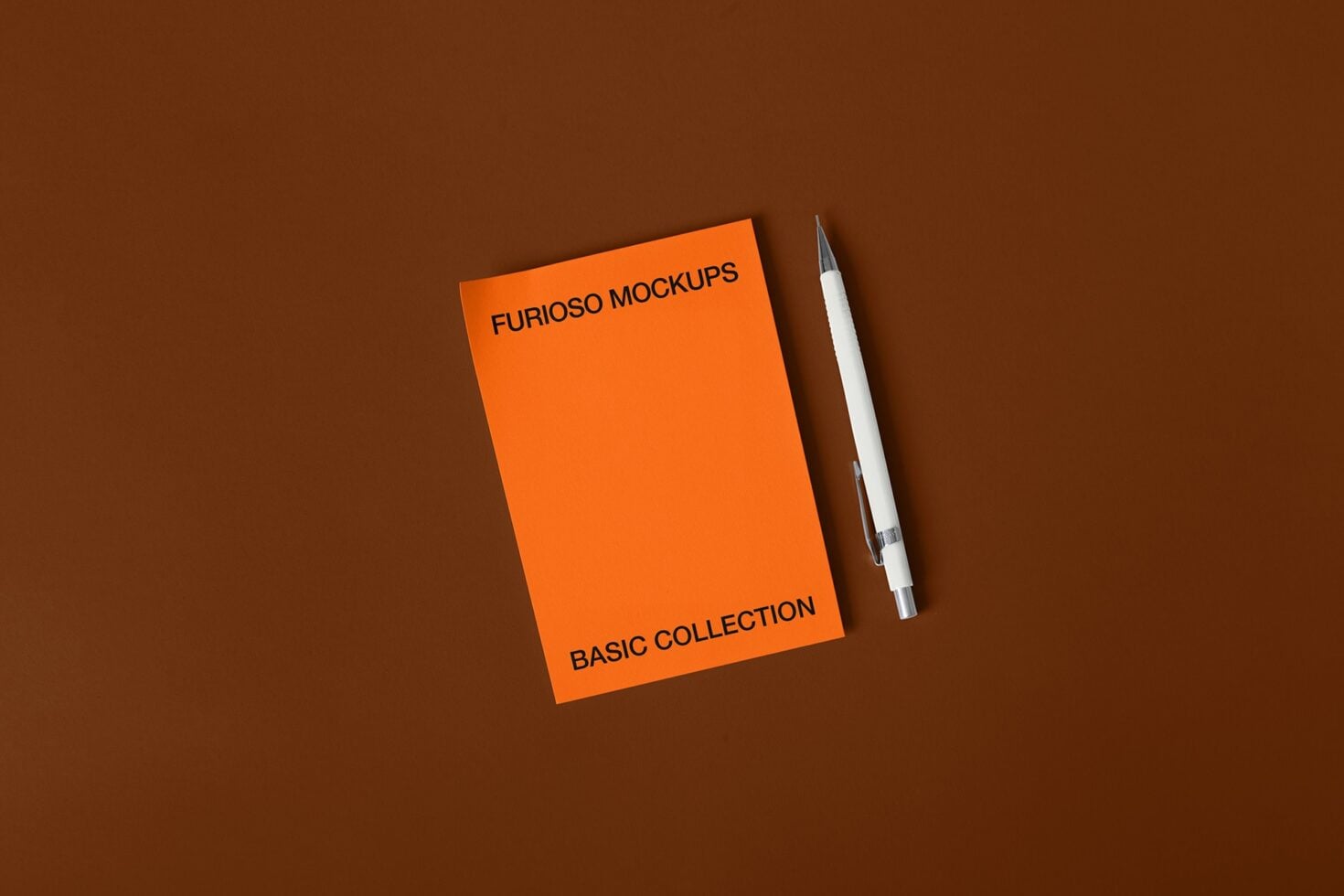 Orange notepad with white pen on brown surface, top left text placement
